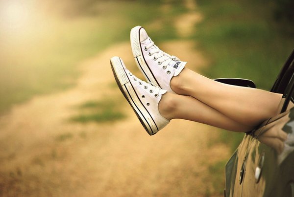 legs hanging out of a car window