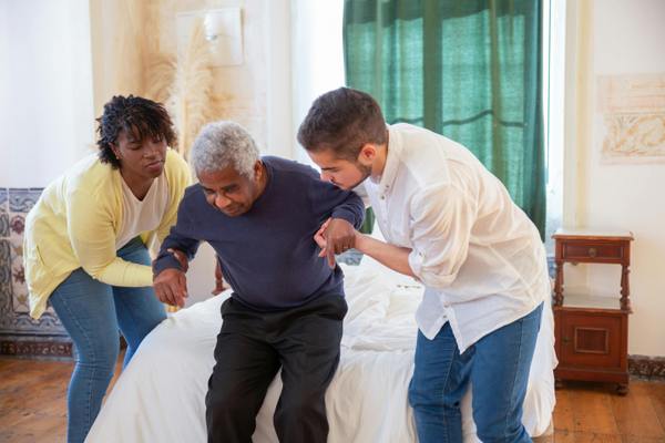 helping an elderly man